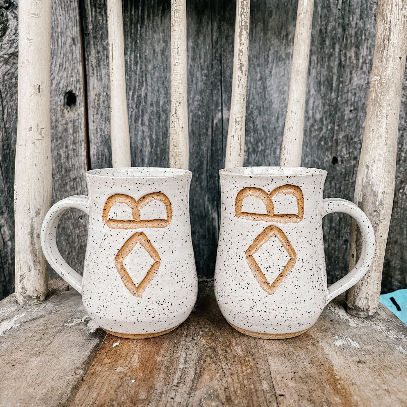 A mug with a cattle brand carved into it by hand