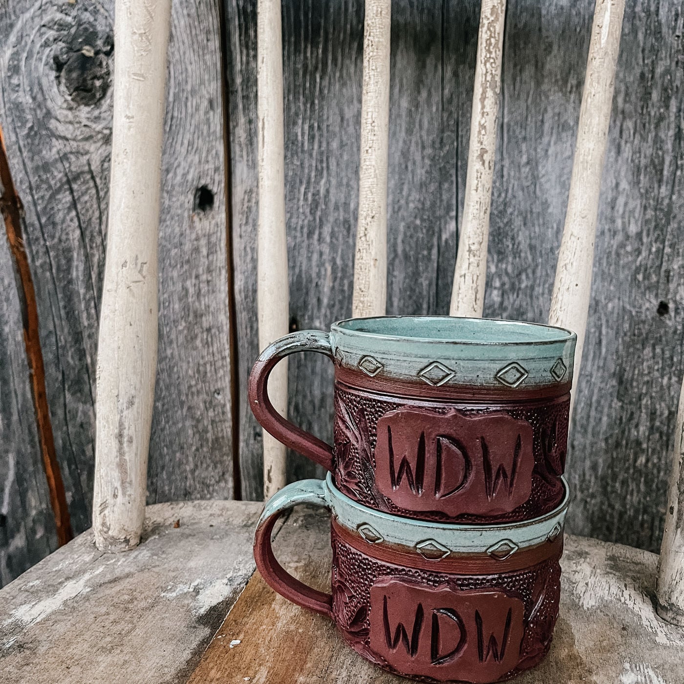 A mug with a cattle brand carved into it by hand