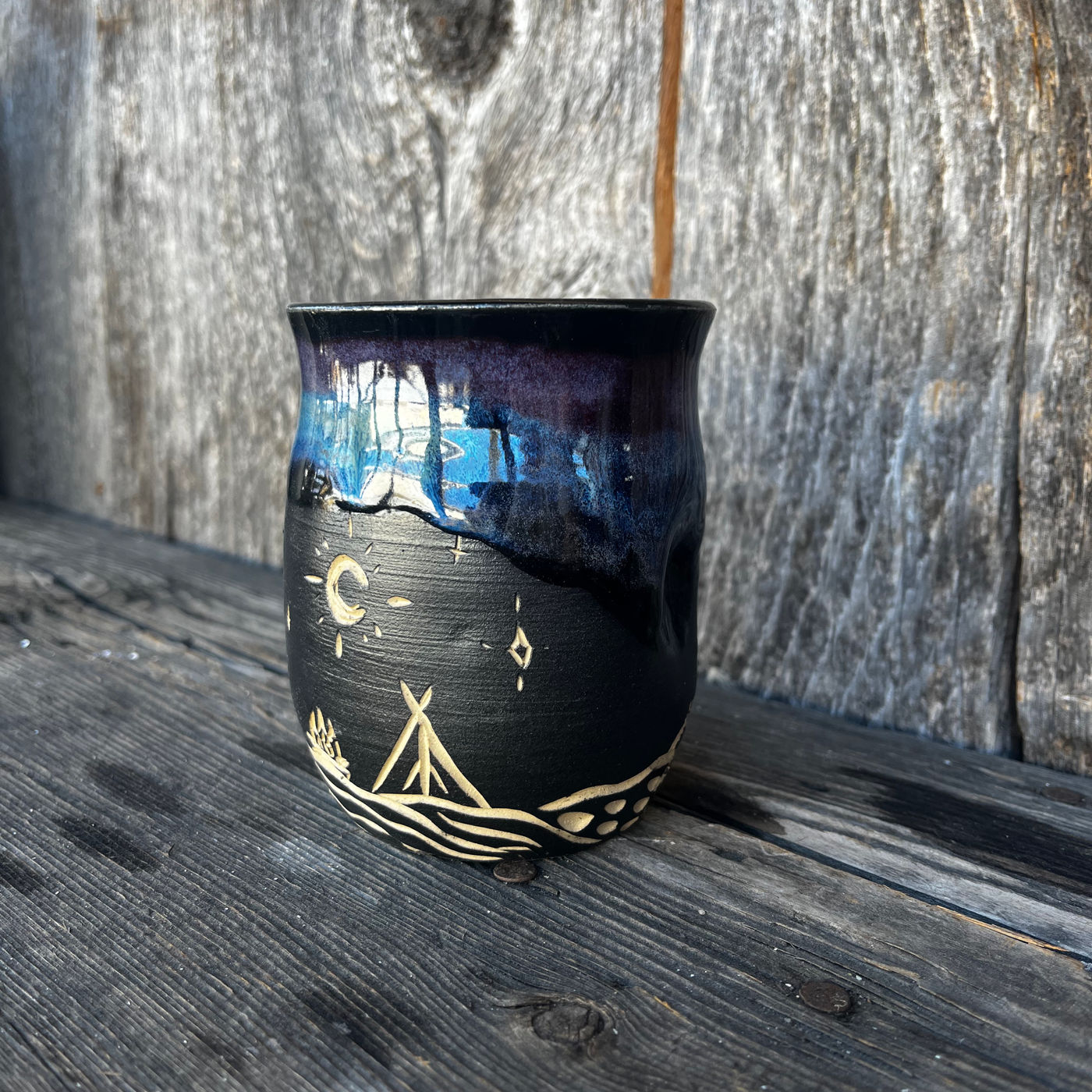 A finished mug in a Northern Lights glaze